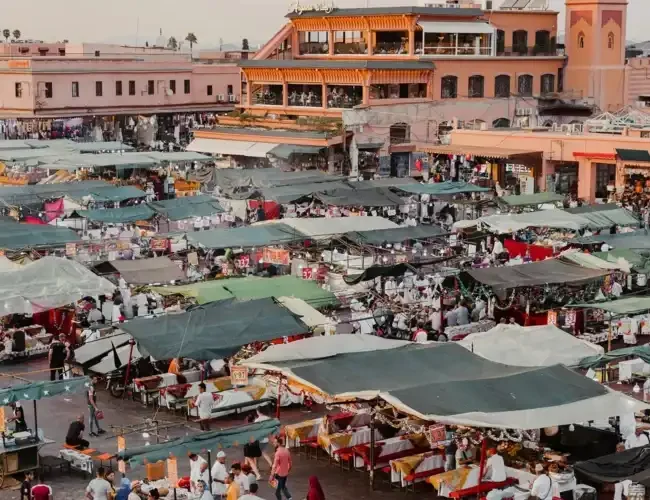 Jemaa el-Fnaa square in Marrakesh Morocco with crowds and food stalls.