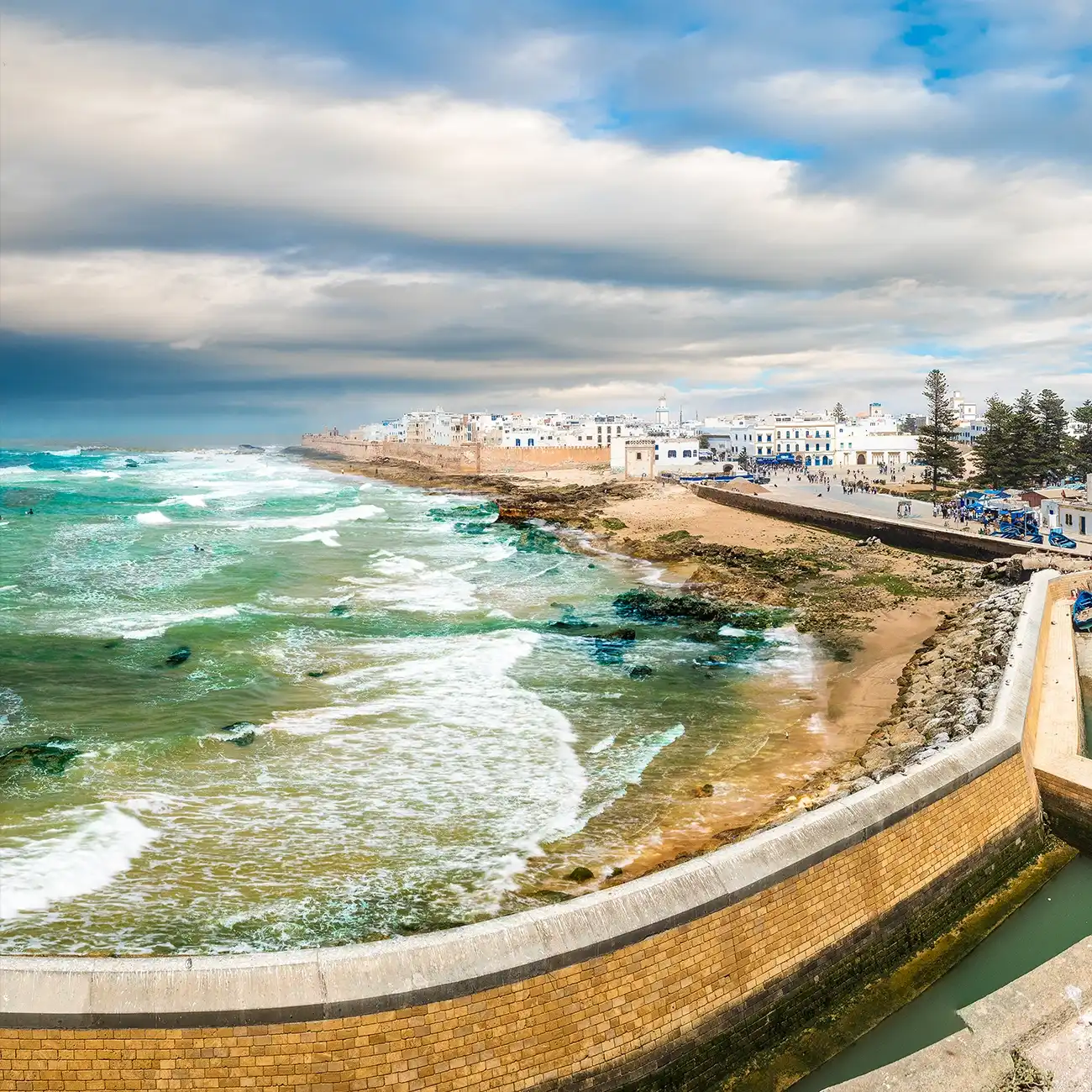 Essaouira City's Medina with white walls and blue doors overlooking the Atlantic Ocean.